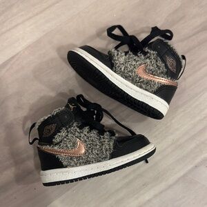 Black high-top sneakers with textured fabric and thick white sole